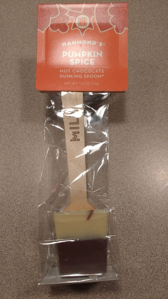 A delicious flavored spoon for coffee (pumpkin spice). A Hammond's dunking spoon sample from the factory tour. Chocolate on the outside. A real spoon waiting underneath.